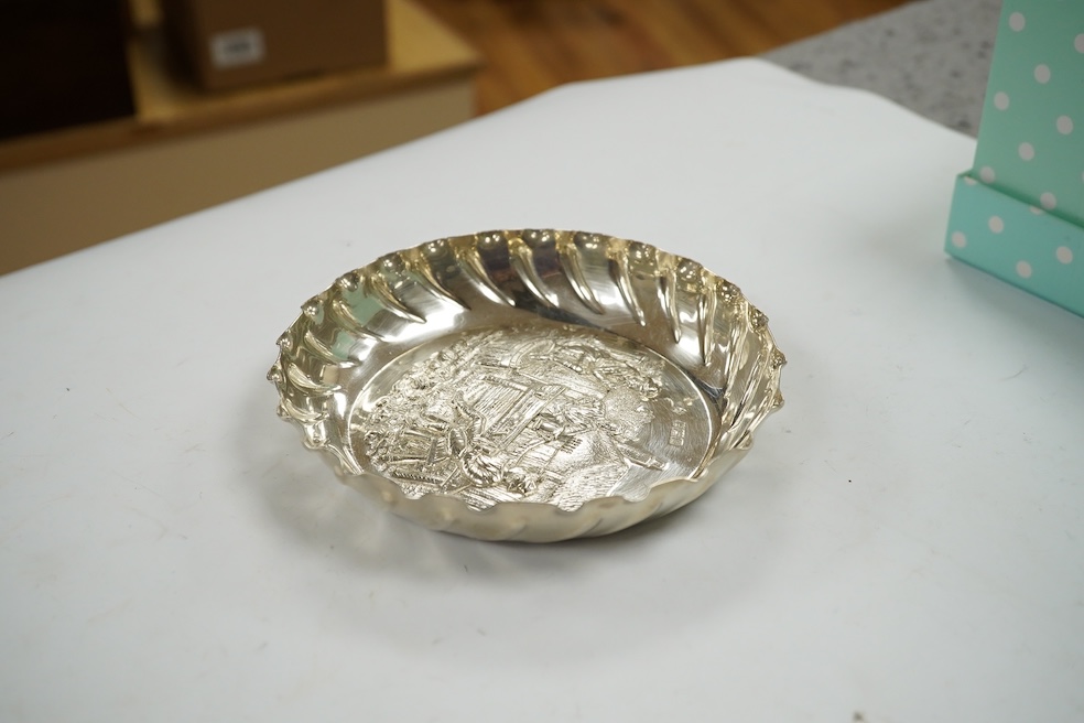 A late Victorian silver shallow dish embossed with imbibers, Mappin Brothers, London, 1897, 13.5cm, 3.8oz. Condition - good